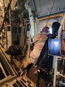 New York Air National Guard Master Sgt. Rich Cestaro, the 106th Rescue Wing ground superintendent, scanning the  Atlantic Ocean from the window of an HC-130J Combat King II search and rescue aircraft June 21, 2023, for a submersible that went missing while diving to the wreck of the Titanic. Several Airmen were scanners looking for the missing Titan submarine in support of the Coast Guard.