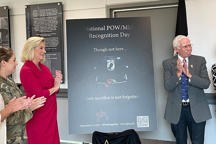 A poster shows a flower on the seat of an empty chair.