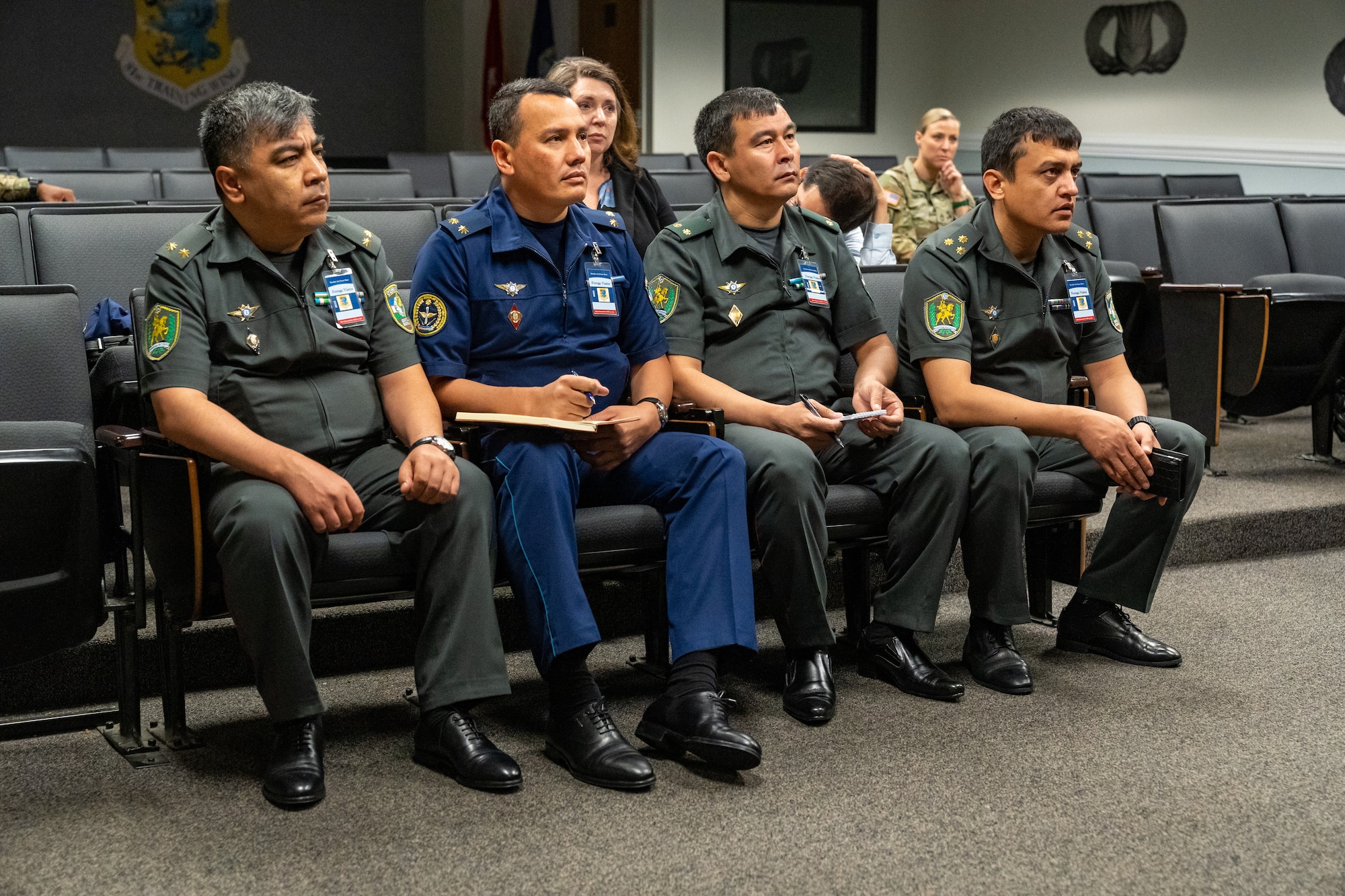 Senior Officers of the Armed Forces of the Republic of Uzbekistan listen and take notes of an overview of courses that the 335th Training Squadron teach to Airmen during a tour of the 335th TRS at Keesler Air Force Base, Mississippi, June 20, 2023.