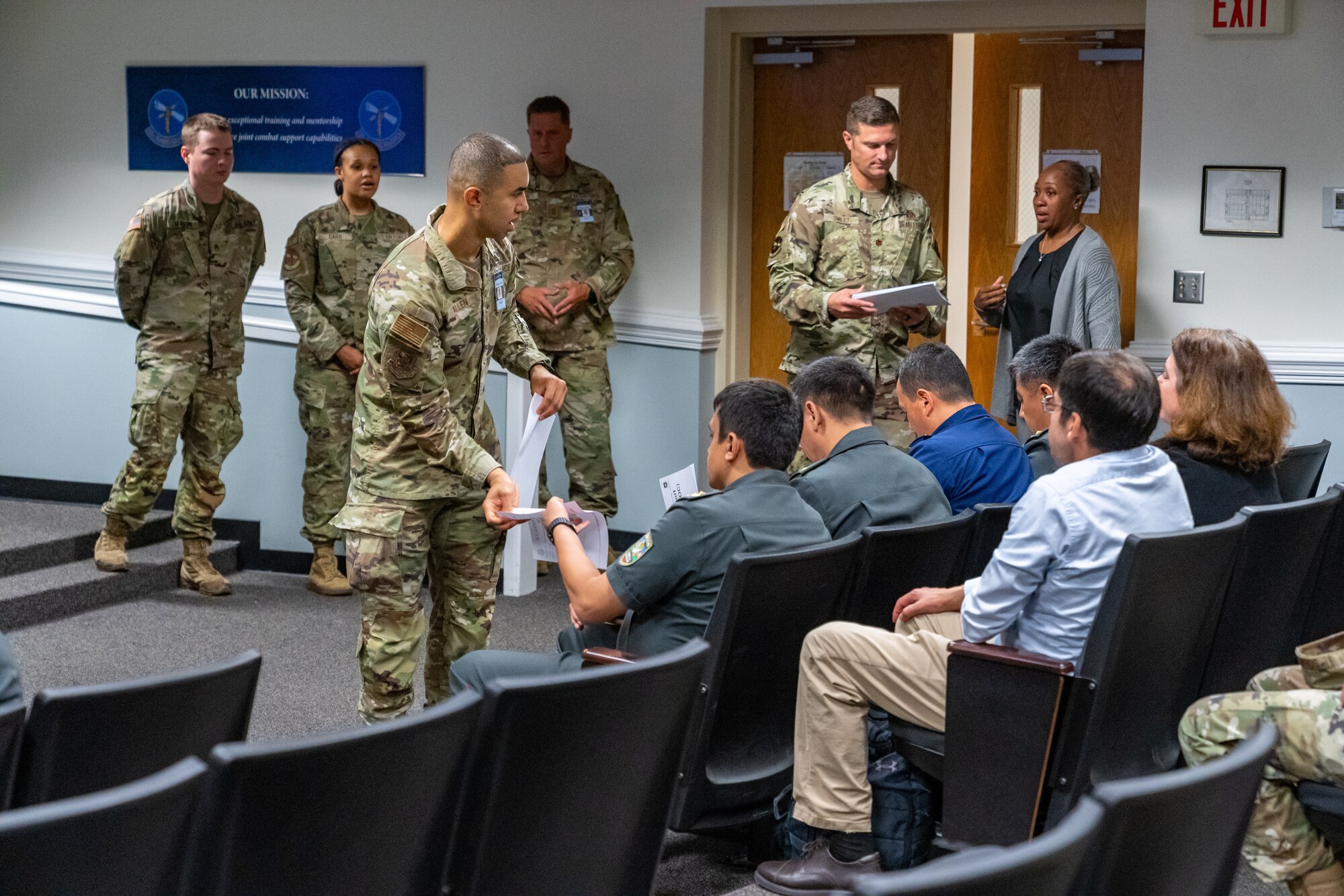 U.S. Air Force Senior Master Sgt. Christopher Allen, National Guard Bureau, Air National Guard liaison, passes out printed material to Senior Officers of the Armed Forces of the Republic of Uzbekistan at Keesler Air Force Base, Mississippi, June 20, 2023.