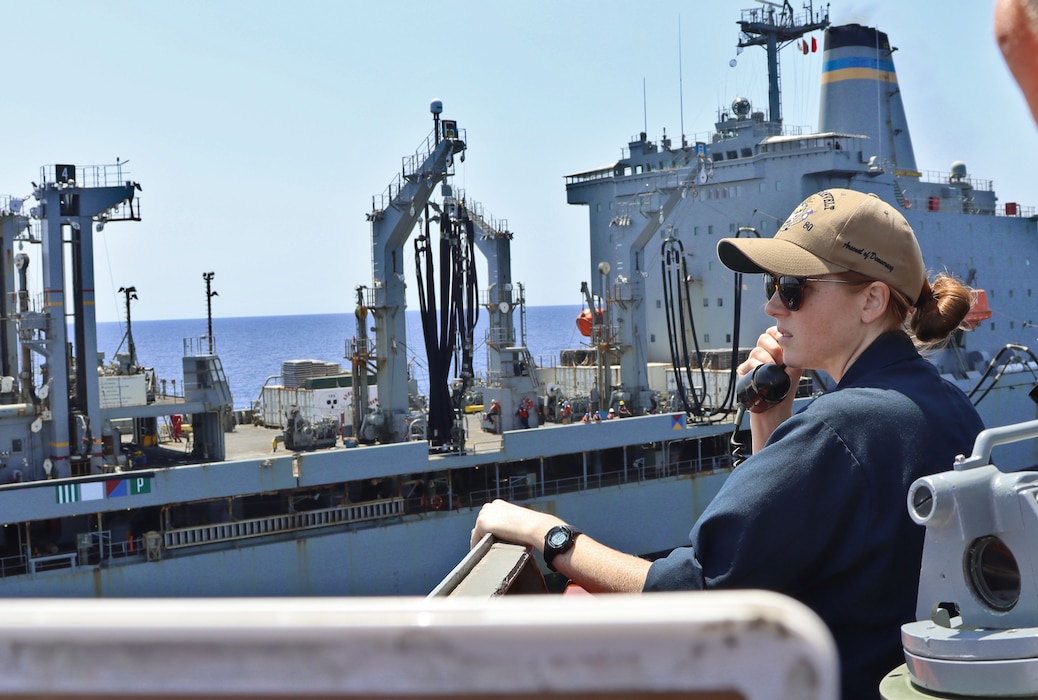 Ensign Brooke Konstanczer conns USS Roosevelt (DDG 80) while alongside USNS Leroy Grumman (T-AO 195) during a replenishment.