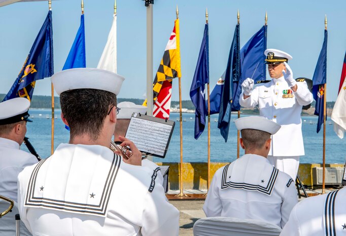 U.S. Navy Band Northwest plays during a Naval Magazine (NAVMAG) Indian Island change of command ceremony that took place on the ammunition pier in Port Hadlock, Washington, June 22, 2023. During the ceremony, Cmdr. Andrew Crouse was relieved as commander of NAVMAG Indian Island while Cmdr. Todd Galvin assumed his position as the incoming commanding officer. (U.S. Navy photo by Mass Communication Specialist 2nd Class Gwendelyn L. Ohrazda)