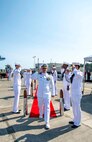 Cmdr. Todd Galvin, incoming commanding officer, is piped aboard during a Naval Magazine (NAVMAG) Indian Island change of command ceremony that took place on the ammunition pier in Port Hadlock, Washington, June 22, 2023. During the ceremony, Cmdr. Andrew Crouse was relieved as commander of NAVMAG Indian Island while Cmdr. Todd Galvin assumed his position as the incoming commanding officer. (U.S. Navy photo by Mass Communication Specialist 2nd Class Gwendelyn L. Ohrazda)