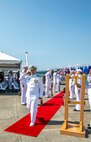 Cmdr. Todd Galvin, incoming commanding officer, is piped ashore during a Naval Magazine (NAVMAG) Indian Island change of command ceremony that took place on the ammunition pier in Port Hadlock, Washington, June 22, 2023. During the ceremony, Cmdr. Andrew Crouse was relieved as commander of NAVMAG Indian Island while Cmdr. Todd Galvin assumed his position as the incoming commanding officer. (U.S. Navy photo by Mass Communication Specialist 2nd Class Gwendelyn L. Ohrazda)