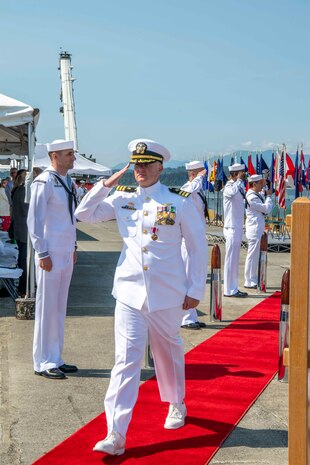 Cmdr. Andrew Crouse, outgoing commanding officer of Naval Magazine (NAVMAG) Indian Island, is piped ashore during a change of command ceremony that took place on the ammunition pier in Port Hadlock, Washington, June 22, 2023. During the ceremony, Cmdr. Andrew Crouse was relieved as commander of NAVMAG Indian Island while Cmdr. Todd Galvin assumed his position as the incoming commanding officer. (U.S. Navy photo by Mass Communication Specialist 2nd Class Gwendelyn L. Ohrazda)