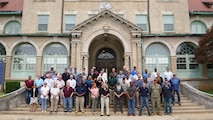 A group of people standing in front of a public works department building.