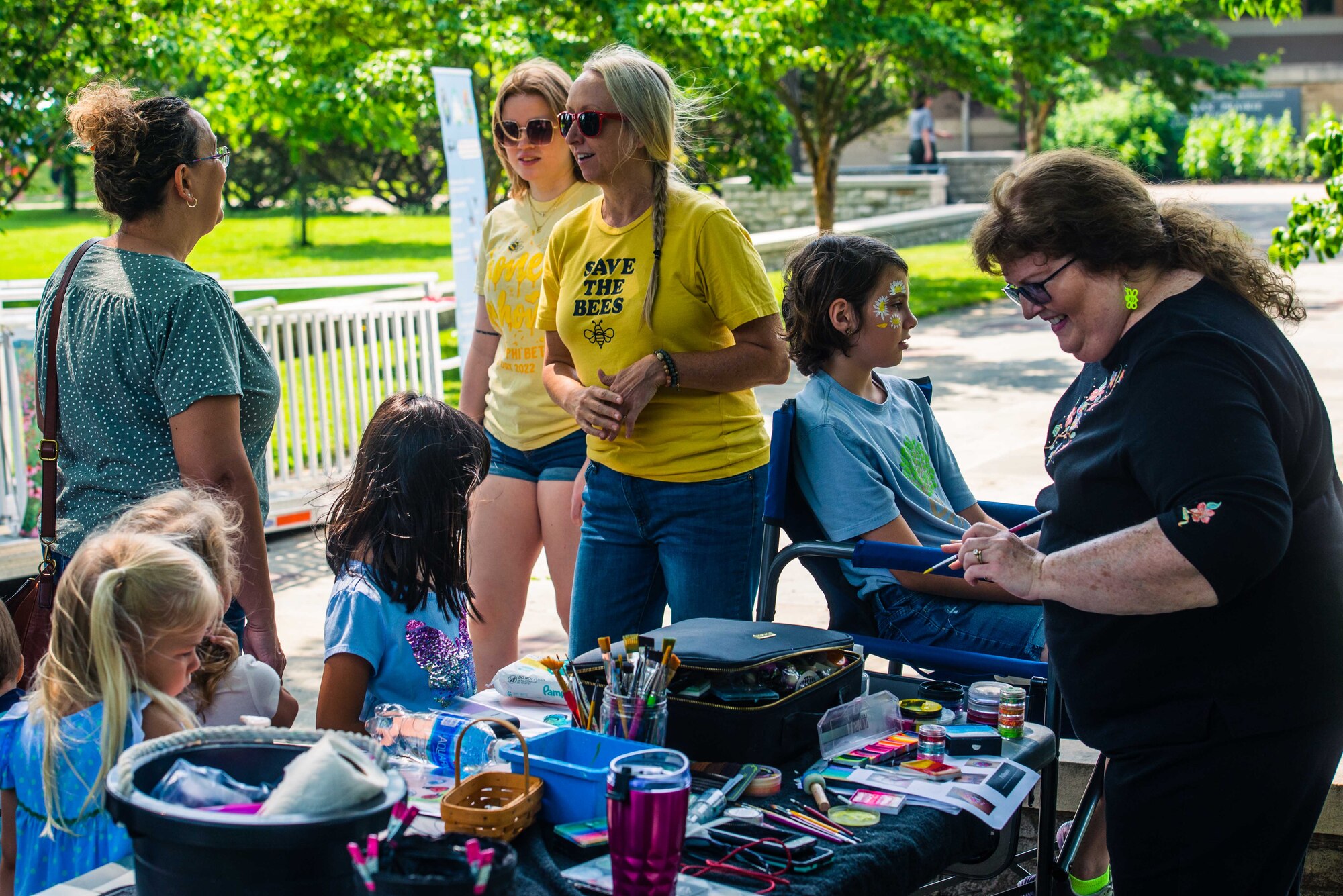 Danielle Trevino, center, biological scientist with the 88th Civil Engineer Group’s Environmental Branch, talks with guests while coworker, Melanie Pershing, right, paints the faces of children attending the Pollinator Expo at the Wright Brothers Memorial, June 21 at the Wright-Brothers Memorial, Dayton, Ohio.  
This is the fifth year of the Pollinator Expo which was started to bring awareness about the decline of pollinator populations. (U.S. Air Force photo by Airman 1st Class James Johnson)