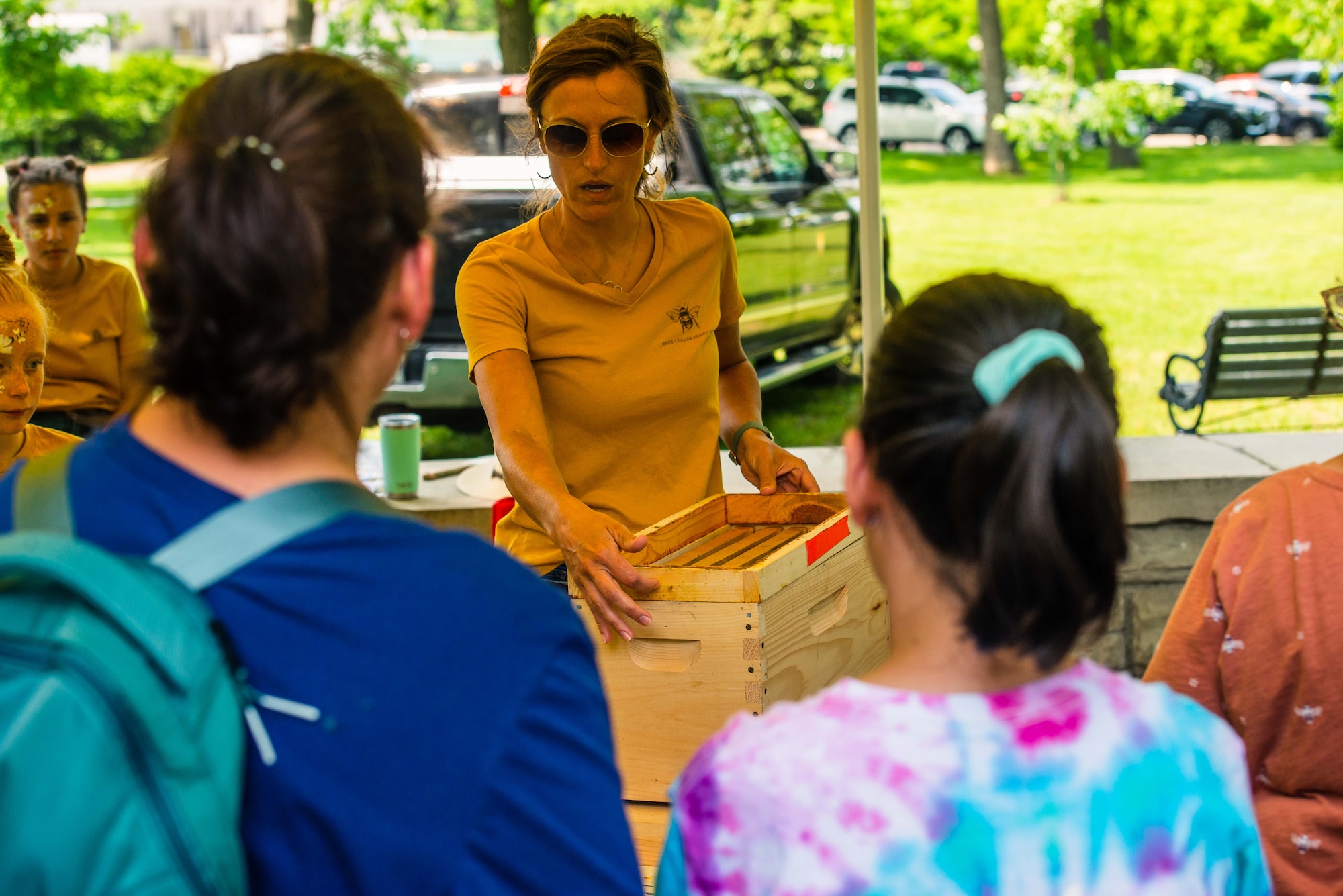 A member of Blue Collar Honey Bees displays a bee hive and describes how honey is produced to attendees of the Pollinator Expo, June 21 at the Wright Brothers Memorial, Dayton, Ohio. Pollinators are essential to the environment and about 35% of the world’s food crops depend on pollinators to be able to produce according to the United States Department of Agriculture. (U.S. Air Force photo by Airman 1st Class James Johnson)