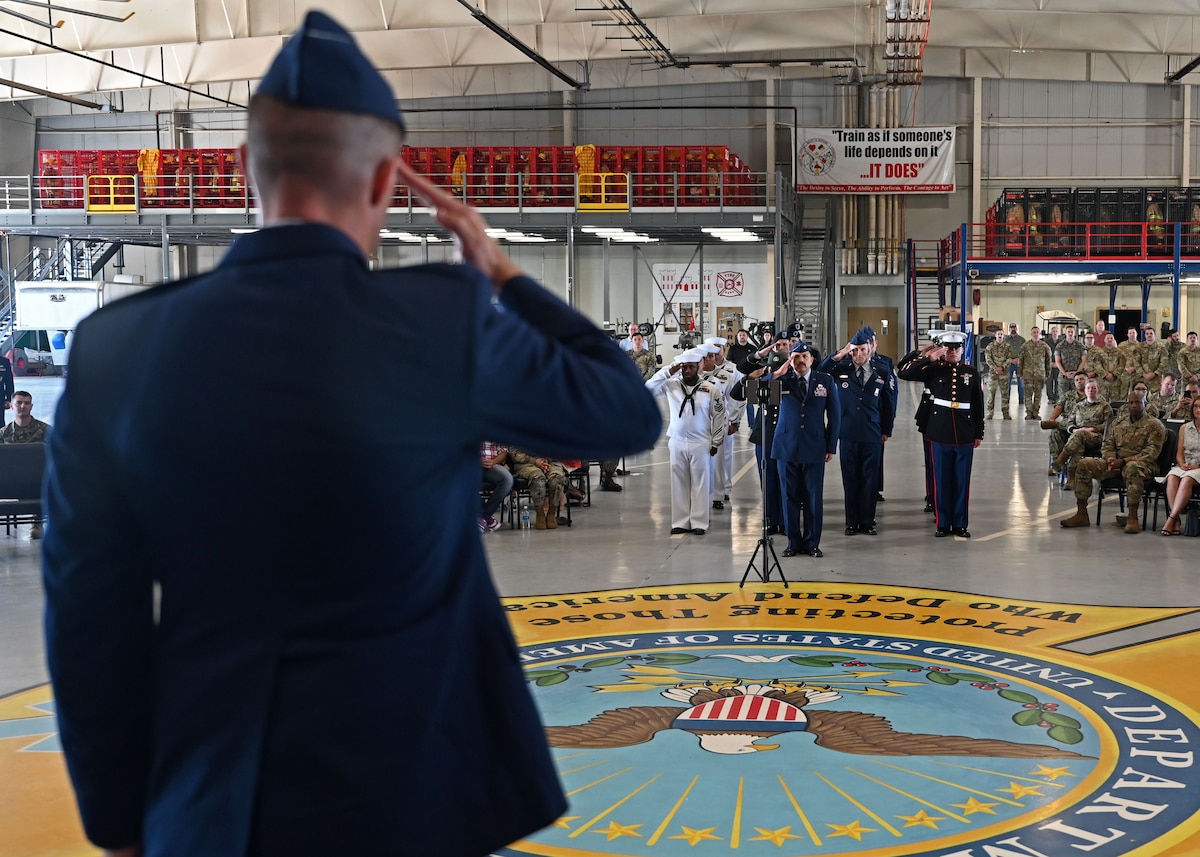 U.S. Air Force Airmen assigned to the 312th Training Squadron present Lt. Col Branden Delong, 312th TRS commander, at the Louis F. Garland Department of Defense Fire Academy, Goodfellow Air Force Base, Texas, June 23, 2023. The salute represents the squadron welcoming their new commander. (U.S. Air Force photo by Senior Airman Sarah Williams)