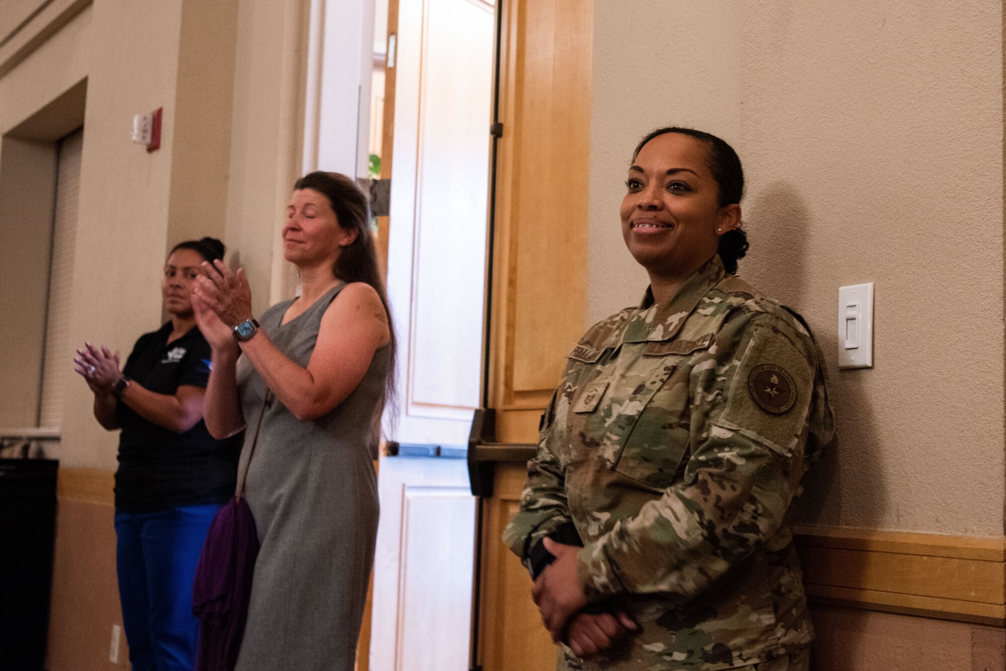 Master Sgt. Opal Poullard, 345th Training Squadron, smiles as she is introduced at The Gateway Club at JBSA-Lackland, Texas, June 14, 2023. Poullard was on base to support healthy living events through the Robert Irvine Foundation’s Breaking Bread with Heroes Program. Poullard, spent 14 years as a Defender before she retrained into a special duty career field and became an Enlisted Aide. Poullard was the winner of the Military Salute Edition of the Food Network show, Chopped. (U.S. Air Force photo by Vanessa R. Adame)