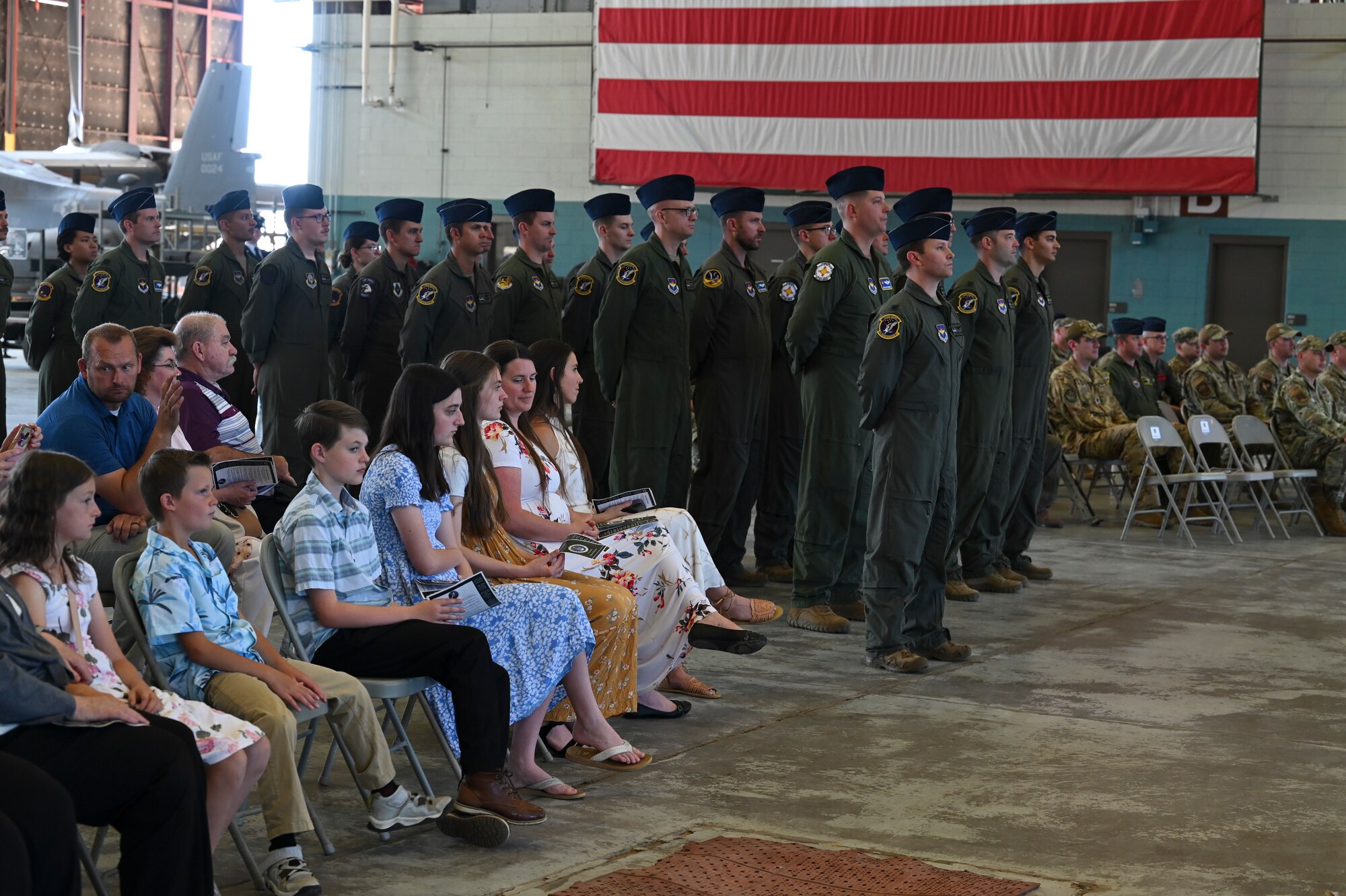 A crowd watches a ceremony.