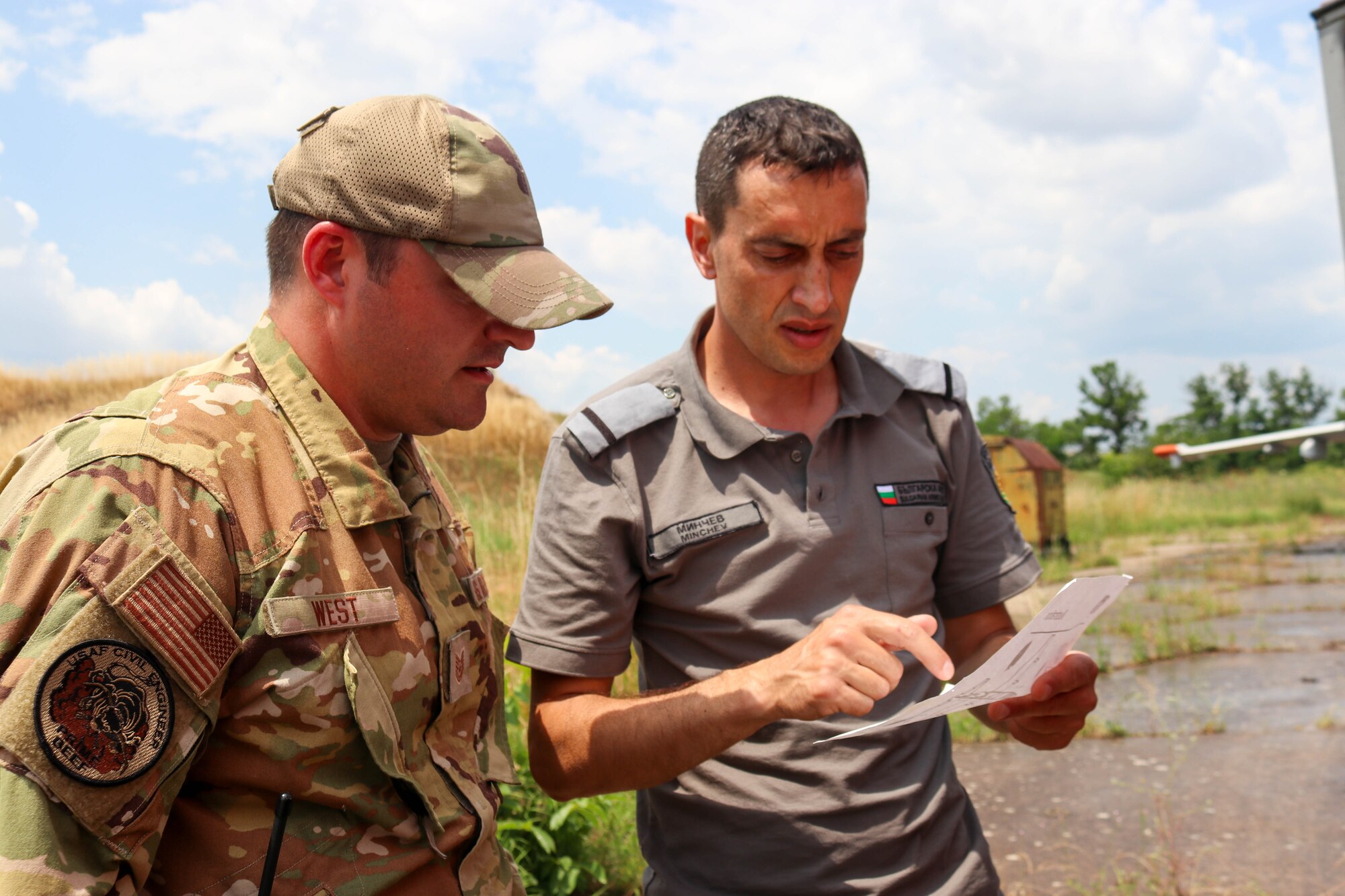 US Air Force firefighter converses with Bulgarian Air Force firefighter