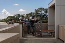U.S. Marines with Marine Corps Base Hawaii Provost Marshal’s Office clear a rooftop during an active shooter response drill, MCBH, June 13, 2023. The exercise tested PMO’s ability to respond to different active shooter threats and scenarios. PMO conducts this training several times a year to train, test and evaluate their ability to respond to any situation they might encounter. (U.S. Marine Corps photo by Lance Cpl. Hunter J. Jones)