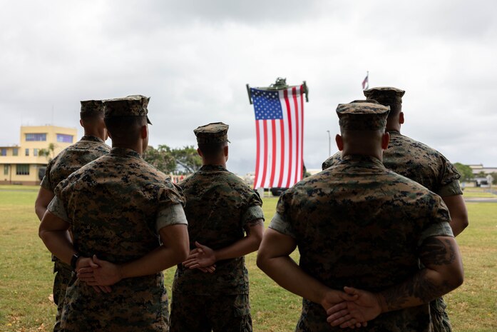 U.S. Marines with 3rd Radio Battalion, III Marine Expeditionary Force, stand at parade rest during a change of command ceremony, Marine Corps Base Hawaii, June 15, 2023. Lt Col. Bryon Owen relinquished command of 3rd Radio Battalion to Lt. Col. Gary Keefer. (U.S. Marine Corps photo by Lance Cpl. Baker)