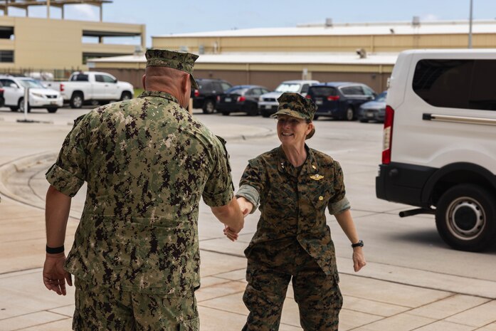 U.S. Navy Rear Adm. Pamela Miller, medical officer of the Marine Corps, right, is greeted by Cmdr. Tim Brender, chief nursing officer, Branch Health Clinic Kaneohe Bay, during a visit to Marine Corps Base Hawaii, June 14, 2023. Miller visited MCBH to conduct battlefield circulation with senior military leaders and to ensure the welfare of Marines, Sailors, and their families. (U.S. Marine Corps photo by Lance Cpl. Clayton Baker)