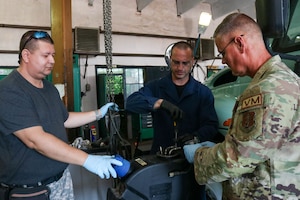 Two Bulgarian Air Force maintenance workers train with a US Air Force maintainer.