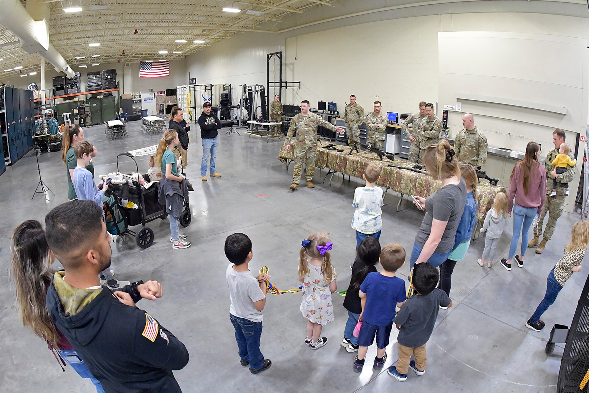 Staff Sgt. Ronald Smith, 75th Security Forces Squadron, briefs guests on a weapons display during 75th SFS Spouses Day June 15, 2023, at Hill Air Force Base, Utah. This event was held to give family guests a closer look into how the squadron operates on a day-to-day basis and is aimed at further developing a sense of inclusion among the spouses and their families. (U.S. Air Force photo by Todd Cromar)