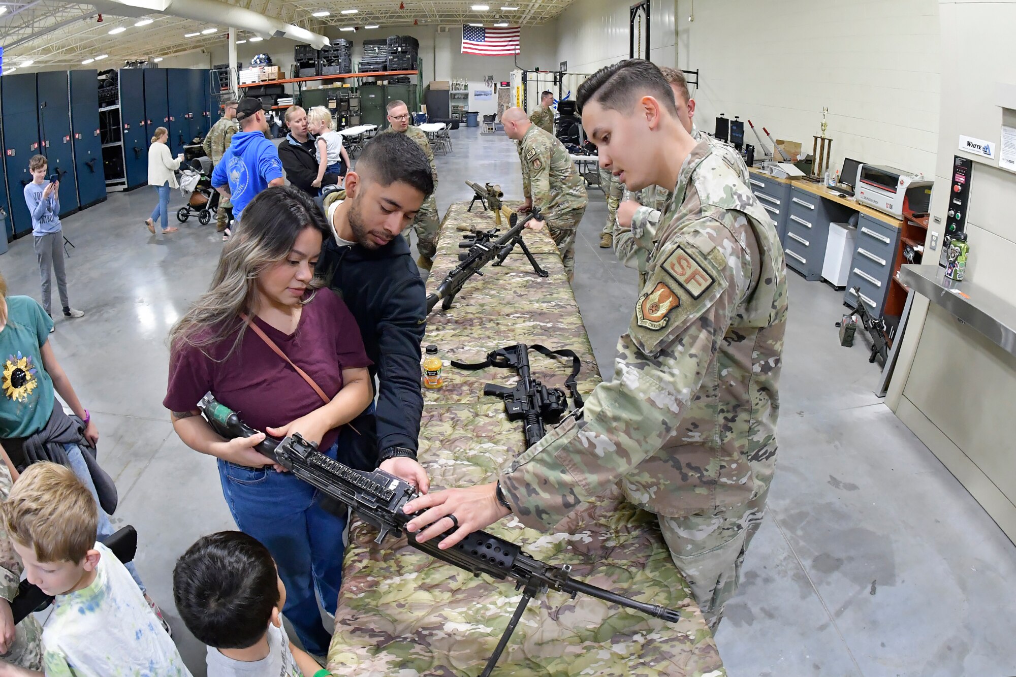 Senior Airman Andrew Jackson, 75th Security Forces Squadron, describes a weapon to family members during 75th SFS Spouses Day June 15, 2023, at Hill Air Force Base, Utah. This event was held to give family guests a closer look into how the squadron operates on a day-to-day basis and is aimed at further developing a sense of inclusion among the spouses and their families. (U.S. Air Force photo by Todd Cromar)