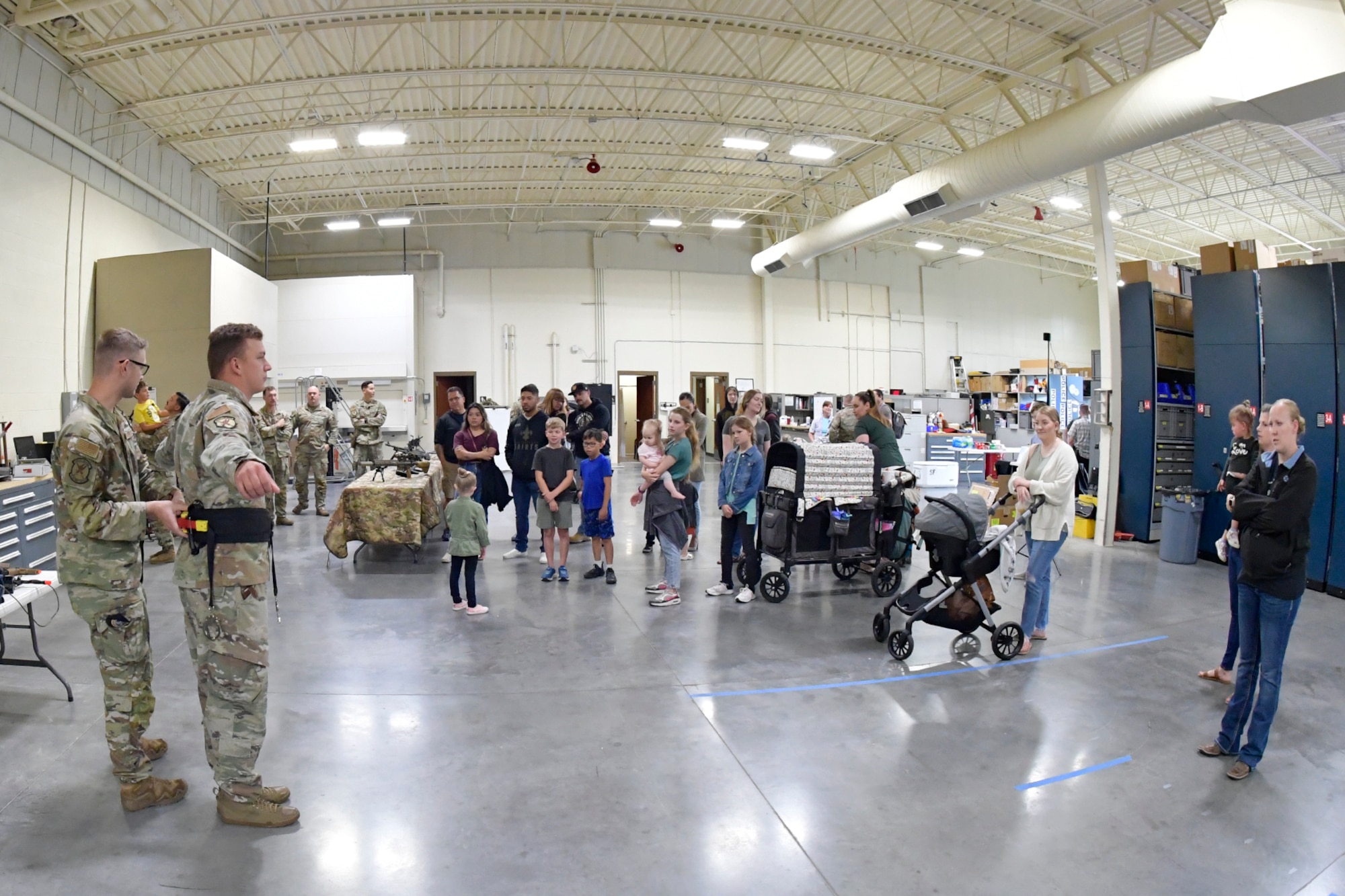 (At left) Staff Sgt. Ian Hemmerling, and Senior Airman Zack College, both 75th Security Forces Squadron, demonstrate a suspect control device during 75th SFS Spouses Day June 15, 2023, at Hill Air Force Base, Utah. This event was held to give family guests a closer look into how the squadron operates on a day-to-day basis and is aimed at further developing a sense of inclusion among the spouses and their families. (U.S. Air Force photo by Todd Cromar)