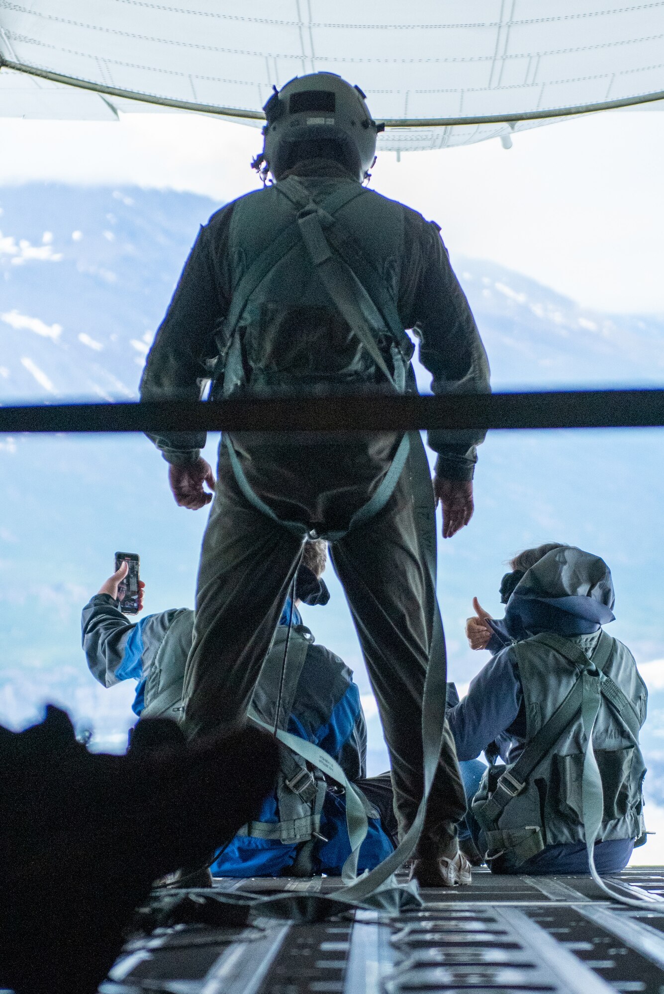 Honorary Commanders of the 176th Wing, employers of Alaska National Guardsmen, and 211th Rescue Squadron aircrew look out the ramp of an HC-130J Combat King II, assigned to the 211th RS during a Boss Lift flight at Joint Base Elmendorf-Richardson, Alaska.