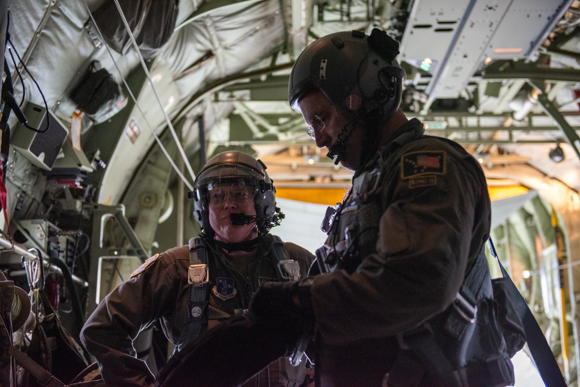 Loadmasters aboard a U.S. Air Force HC-130J Combat King II assigned to the 211th Rescue Squadron prepare to land during a Boss Lift flight at Joint Base Elmendorf-Richardson, Alaska.