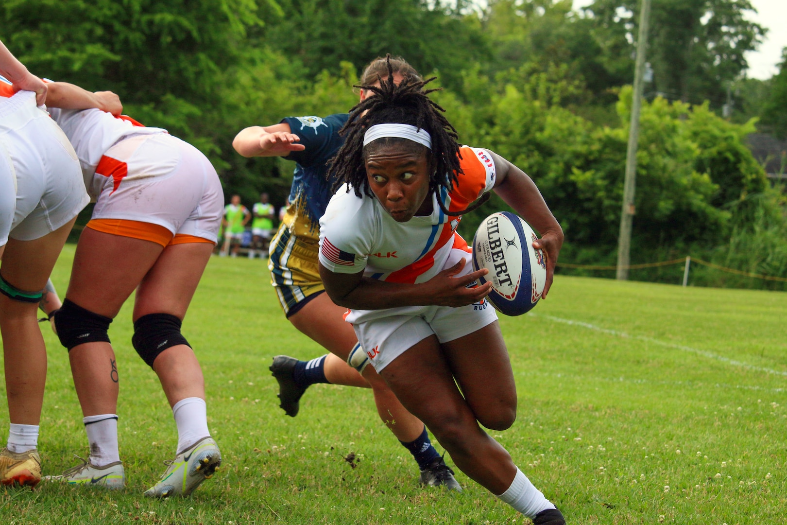 Coast Guard Petty Officer 3rd Class Ra'Shaun Coker of Air Station Barbers Point, Hawaii pulls away from the scrum to score her consecutive try in Coast Guard's 20-14 win over Navy to kick off the 2023 Armed Forces Sports Women's Rugby Championship held in conjunction with the Cape Fear 7's Rugby Tournament in Wilmington, N.C.  Championship features teams from the Army, Marine Corps, Navy, Air Force (with Space Force players), and Coast Guard.  (Dept. of Defense Photo by Mr. Steven Dinote, Released)