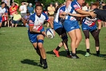 Tech Sgt. Tanya Siford of Anderson AFB, Guam takes control during Air Force's defeat of Army during the 2023 Armed Forces Sports Women's Rugby Championship held in conjunction with the Cape Fear 7's Rugby Tournament in Wilmington, N.C.  Championship features teams from the Army, Marine Corps, Navy, Air Force (with Space Force players), and Coast Guard.  (Dept. of Defense Photo by Mr. Steven Dinote, Released)
