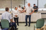 Master Sgt. Opal Poullard, 345th Training Squadron, smiles as Chef Robert Irvine, celebrity chef and television host, introduces her at a cooking demonstration, at JBSA-Lackland, Texas, June 15, 2023. Poullard, who’s an Advanced Culinary Instructor for the Joint Culinary Center of Excellence, was on base to support healthy living events through the Robert Irvine Foundation’s Breaking Bread with Heroes Program. Poullard, spent 14 years as a Defender before she retrained into a special duty career field and became an Enlisted Aide. Poullard was the winner of the Military Salute Edition of the Food Network show, Chopped. (U.S. Air Force photo by Greg Walker)