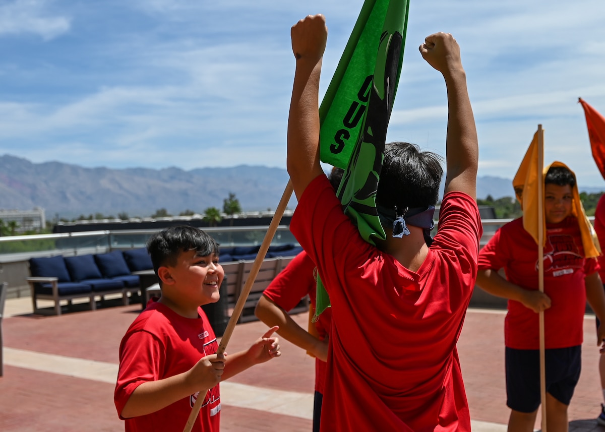 A photo of children celebrating completing an obstacle course.