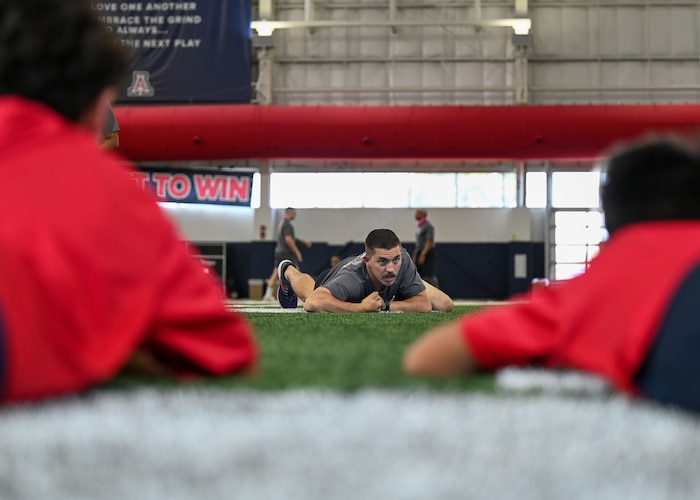 A photo of a man demonstrating how to perform a low crawl.