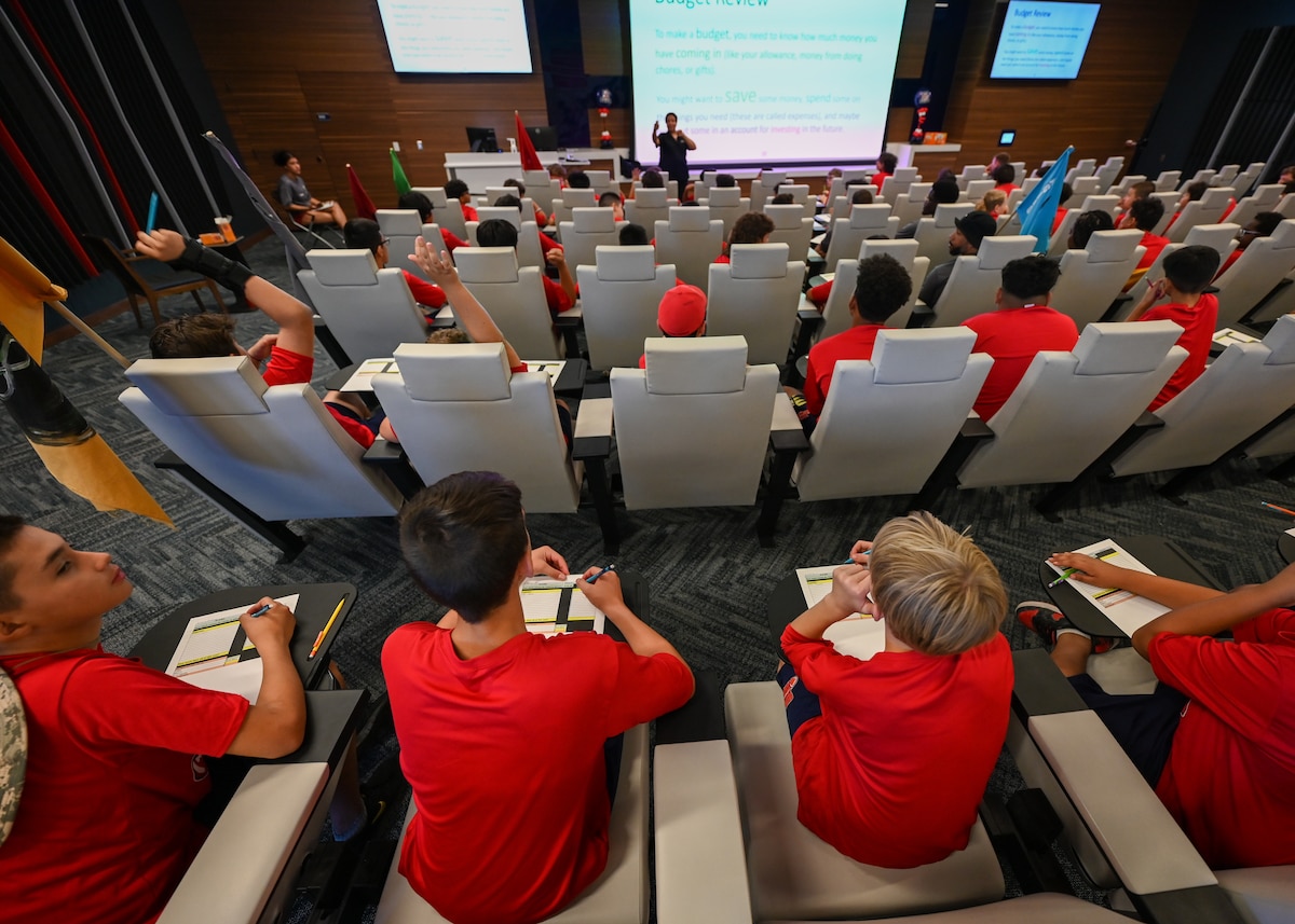 A photo of children sitting in a classroom during a presentation.