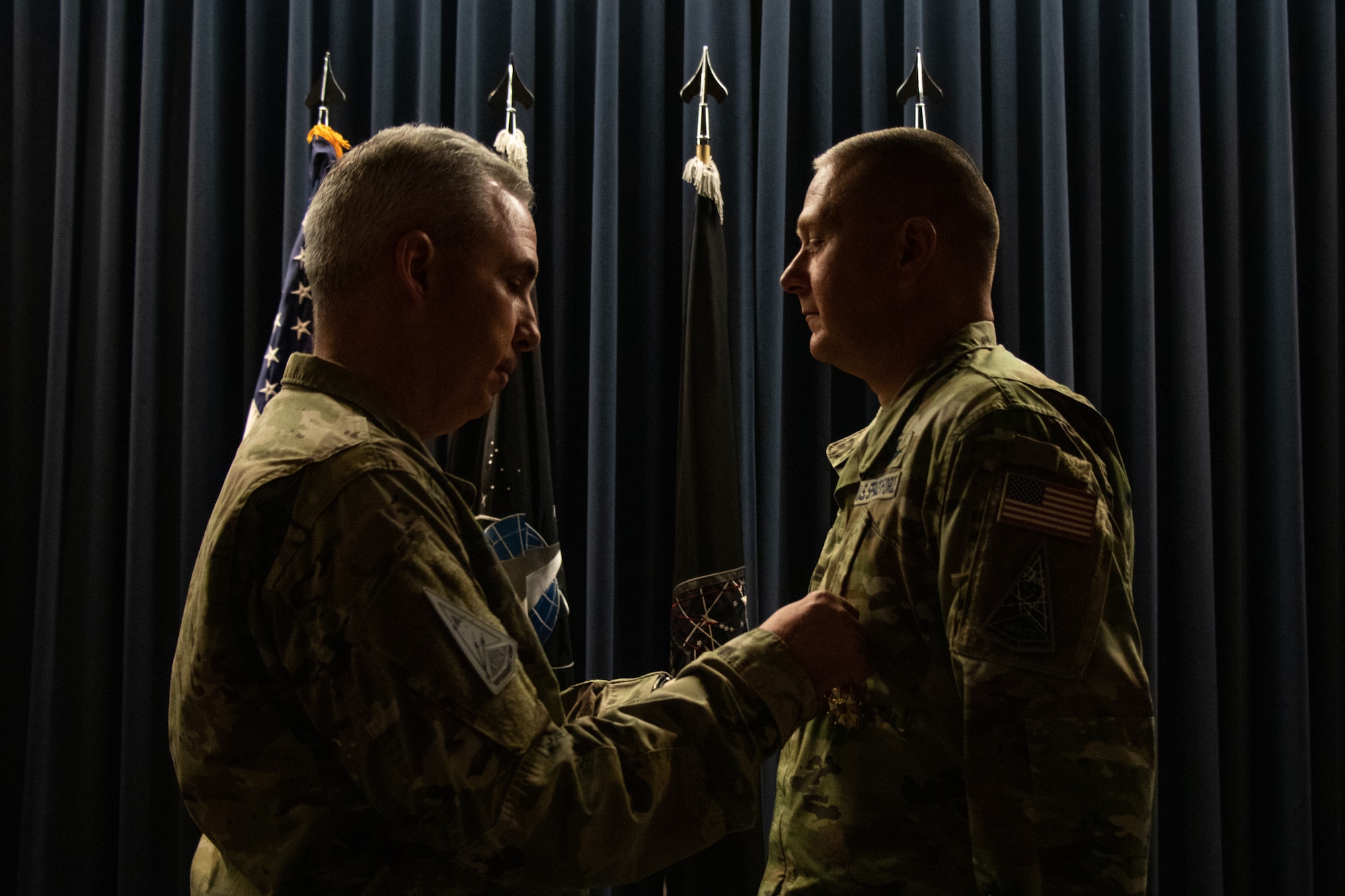 U.S. Space Force Lt. Gen. Stephen Whiting, commander, Space Operations Command, (left) pins the Legion of Merit ribbon on outgoing Delta 2-Space Domain Awareness (DEL2) commander, Col. Marc Brock, (right) during DEL2’s Change of Command ceremony June 23, 2023, at Peterson Space Force Base. (U.S. Space Force photo by Emily Peacock)