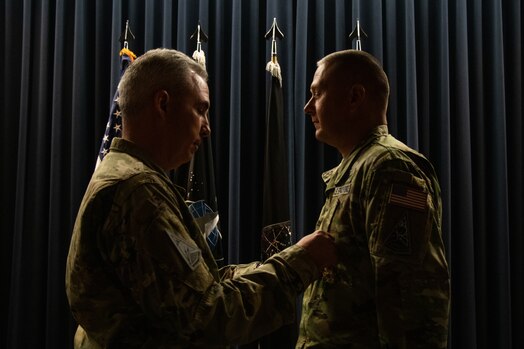  U.S. Space Force Lt. Gen. Stephen Whiting, commander, Space Operations Command, (left) pins the Legion of Merit ribbon on outgoing Delta 2-Space Domain Awareness (DEL2) commander, Col. Marc Brock, (right) during DEL2’s Change of Command ceremony June 23, 2023, at Peterson Space Force Base. (U.S. Space Force photo by Emily Peacock)