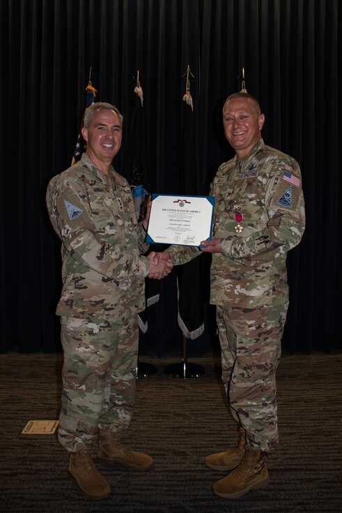  U.S. Space Force Lt. Gen. Stephen Whiting, commander, Space Operations Command, (left) awards the Legion of Merit to outgoing Delta 2-Space Domain Awareness (DEL2) commander, Col. Marc Brock, (right) during DEL2’s Change of Command ceremony June 23, 2023, at Peterson Space Force Base. (U.S. Space Force photo by Emily Peacock)
