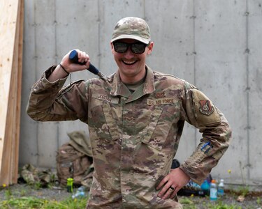 U.S. Air Force Senior Airman Alex Jordan, 773d Civil Engineer Squadron, poses with his hammer at Camp Mad Bull at Joint Base Elmendorf-Richardson, Alaska.