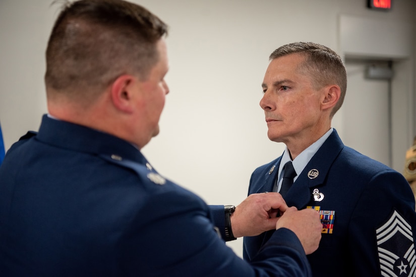 Chief Master Sgt. Donald Hartman, right, outgoing senior enlisted leader for the 123rd Force Support Squadron, is pinned with the Meritorious Service Medal by Lt. Col. Kevin Krauss, 123rd Contingency Response Support Squadron commander, during Hartman’s retirement ceremony at the Kentucky Air National Guard Base in Louisville, Ky., May 21, 2023. Hartman is retiring after 23 years of military service. (U.S. Air National Guard photo by Tech. Sgt. Joshua Horton)