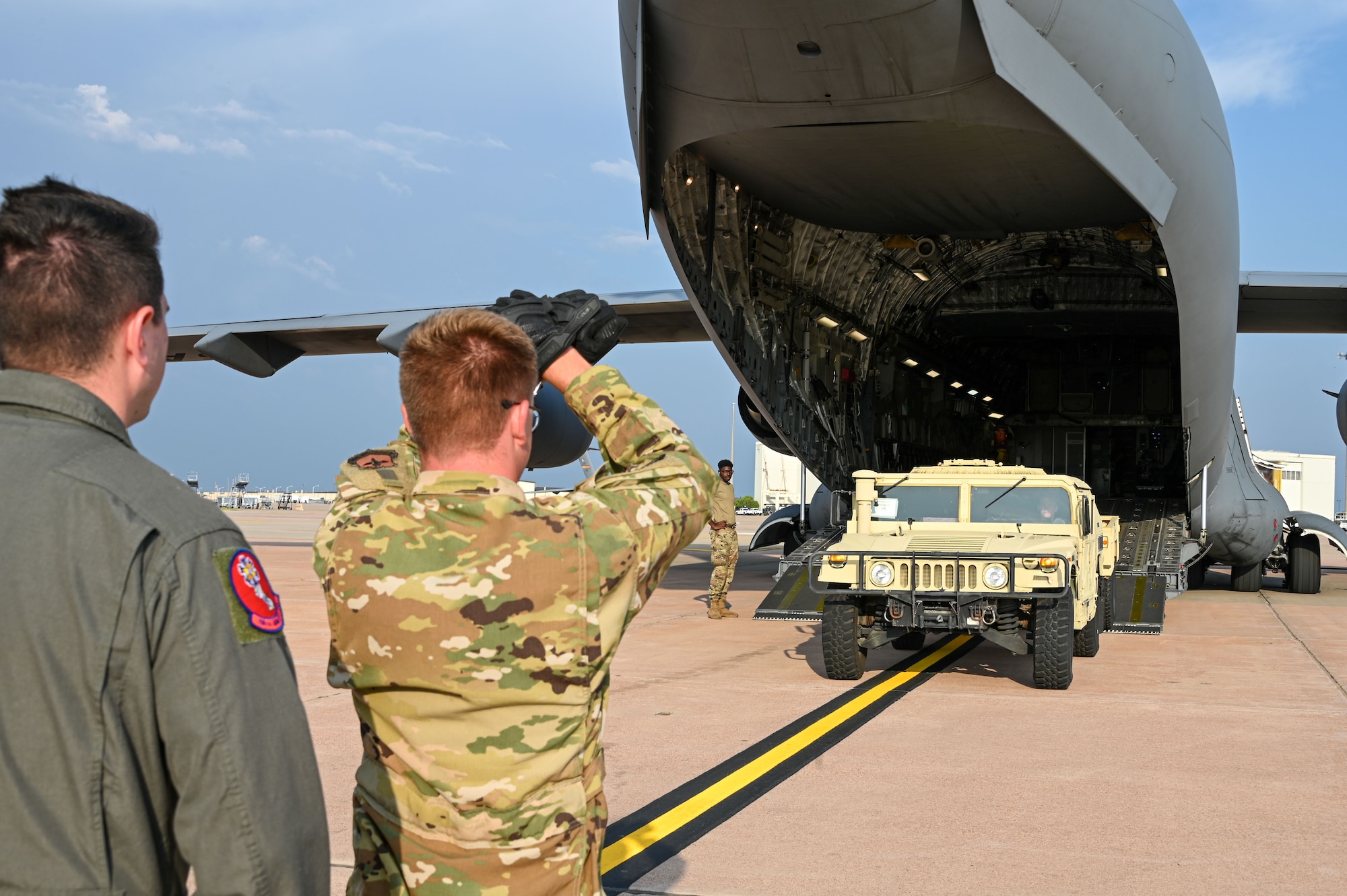 U.S. Air Force Staff Sgt. Douglas Gerrity (left), 58th Airlift Squadron loadmaster instructor, trains Airman 1st Class Donald Miller (right), 97th Training Squadron student, on how to properly load equipment onto a C-17 Globemaster III at Altus Air Force Base, Oklahoma, June 23, 2023. Gerrity has served for six years as a loadmaster and recently reenlisted for another four years. (U.S. Air Force photo by Senior Airman Kayla Christenson)