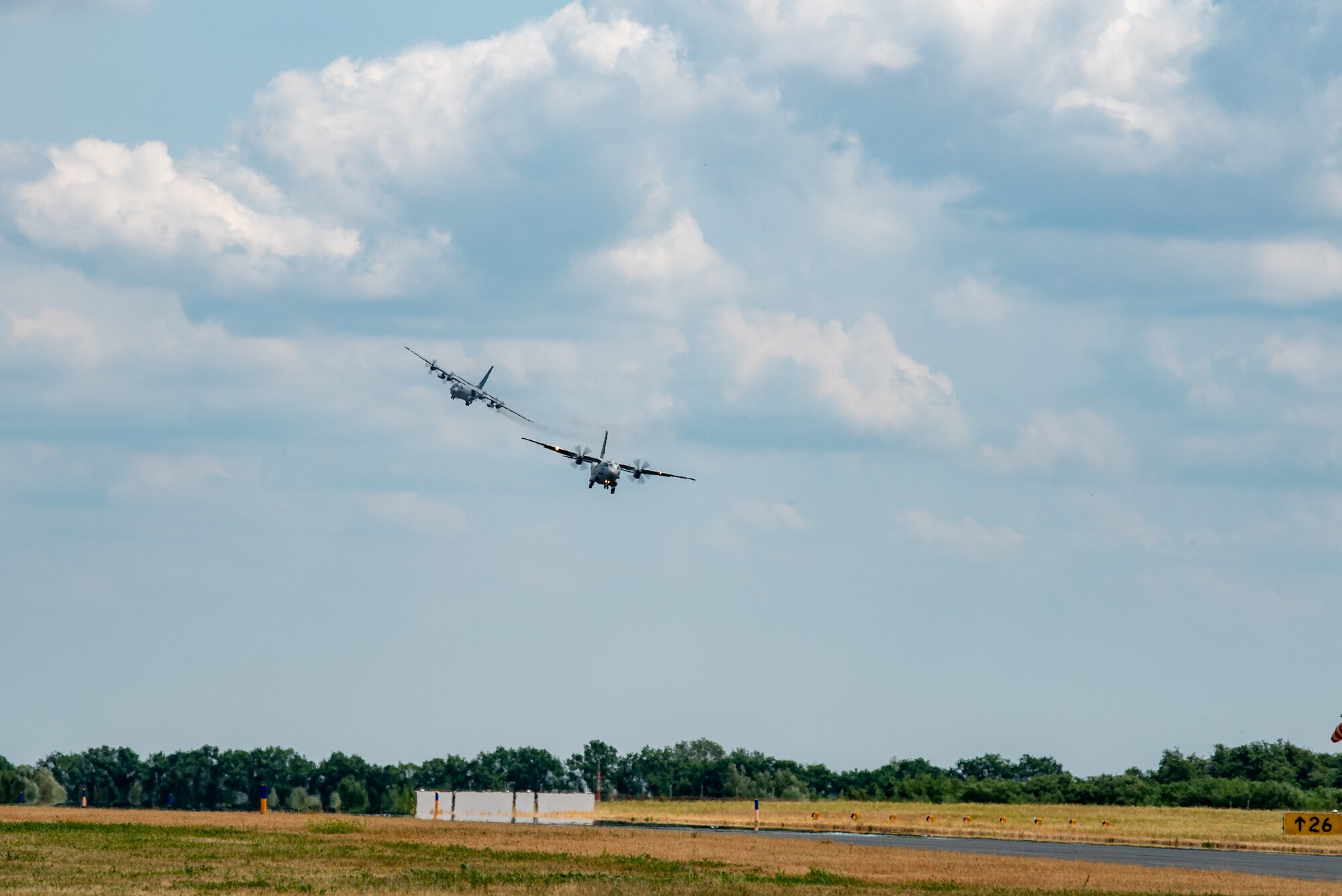 A Romanian C-27 Spartan aircraft lands in front of a U.S. Air Force C-130 Hercules assigned to the 139th Airlift Wing, Missouri National Guard, during exercise Air Defender 2023 (AD23) at Wunstorf Air Base, Germany, June 19, 2023. Exercise AD23 integrates both U.S. and allied air-power to defend shared values, while leveraging and strengthening vital partnerships to deter aggression around the world. (U.S. Air National Guard photo by Master Sgt. Phil Speck)