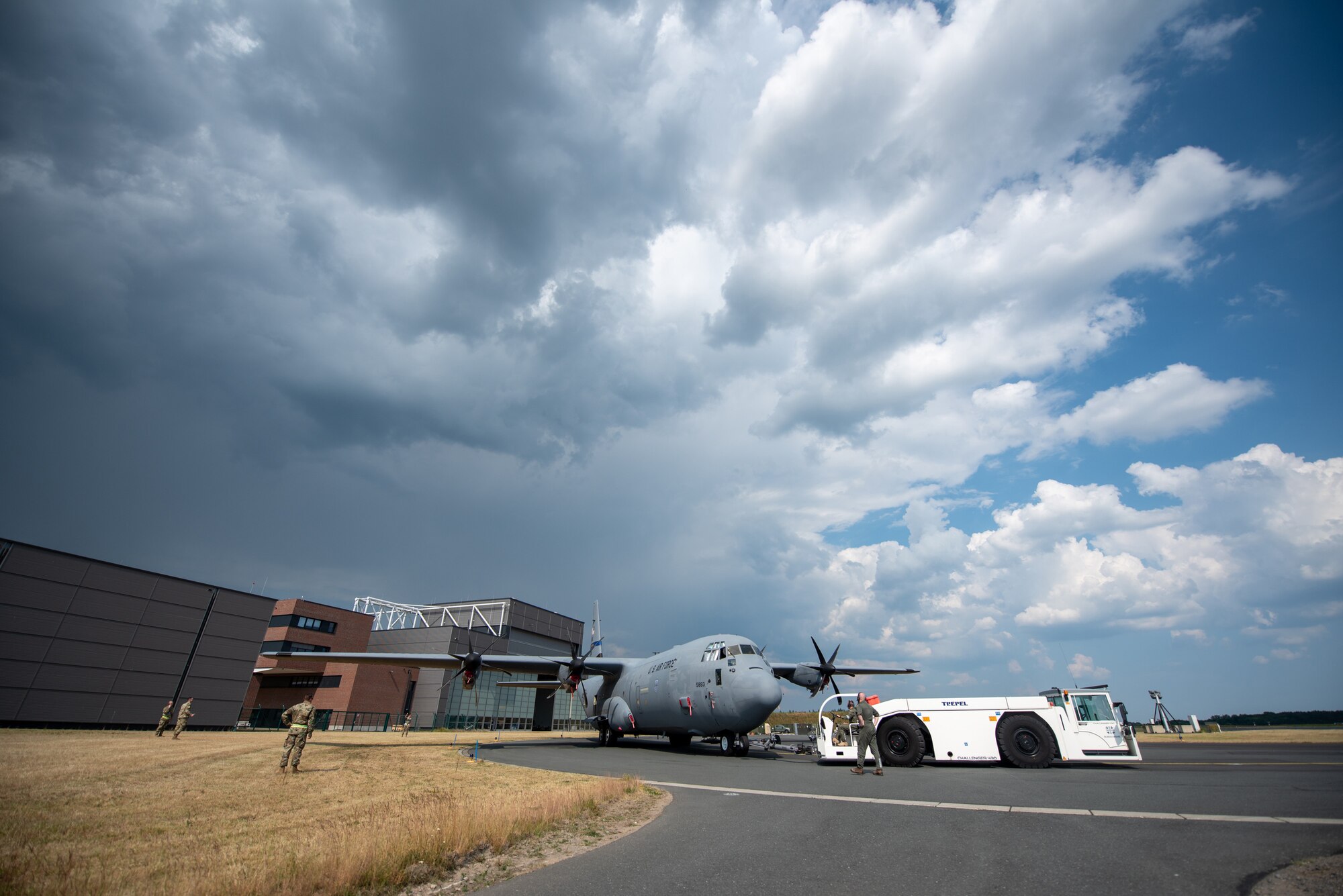 A C-130J Super Hercules assigned to the 123rd Airlift Wing, Kentucky National Guard, is towed by a German aircraft tug at Wunstorf Air Base, Wunstorf, Germany, June 12, 2023.  Exercise Air Defender integrates both U.S. and allied air-power to defend shared values, while leveraging and strengthening vital partnerships to deter aggression around the world. (U.S. Air National Guard photo by Master Sgt. Phil Speck)