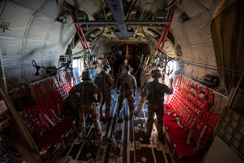 American and German jumpmasters prepare German paratroopers before a jump during exercise Air Defender 2023 in Saarbrucken, Germany, June 15, 2023. AD23 integrates both U.S. and allied air-power to defend shared values, while leveraging and strengthening vital partnerships to deter aggression around the world. (U.S. Air National Guard photo by Master Sgt. Phil Speck)
