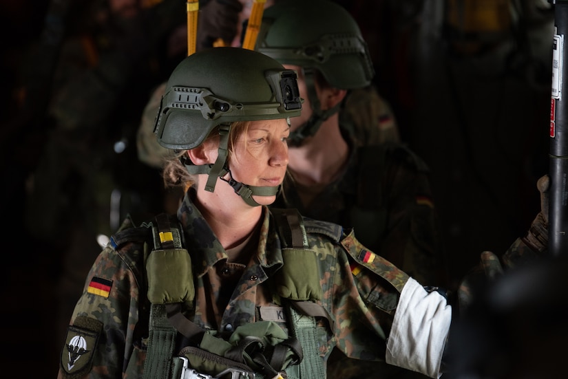 A German Armed Forces jumpmaster looks out the paratrooper door on a 123rd Airlift Wing C-130J Super Hercules during exercise Air Defender 2023 in Saarbrucken, Germany, June 15, 2023. AD23 integrates both U.S. and allied air-power to defend shared values, while leveraging and strengthening vital partnerships to deter aggression around the world. (U.S. Air National Guard photo by Master Sgt. Phil Speck)
