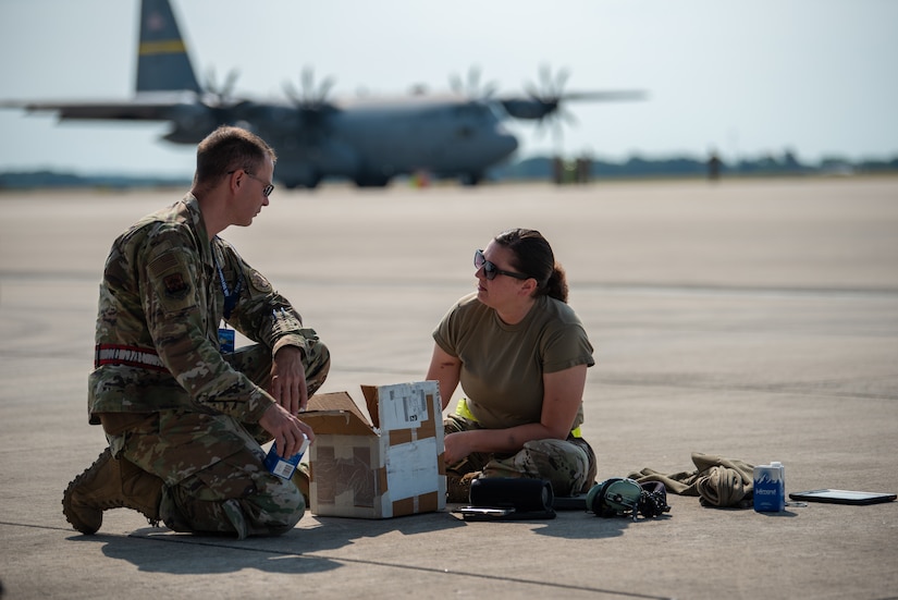 U.S. Air Force Tech. Sgt. Jessica Jones, right, an avionics technician assigned to the 123rd Maintenance Squadron, 123rd Airlift Wing, Kentucky National Guard, and Master Sgt. Wyatt Shupe , an electrical environmental technician assigned to the 165th Maintenance Squadron, 165th Airlift Wing, Georgia National Guard, discuss a safety valve replacement during exercise Air Defender 2023 (AD23) at Wunstorf Air Base, Germany, June 19, 2023. Exercise AD23 integrates both U.S. and allied air-power to defend shared values, while leveraging and strengthening vital partnerships to deter aggression around the world. (U.S. Air National Guard photo by Master Sgt. Phil Speck)