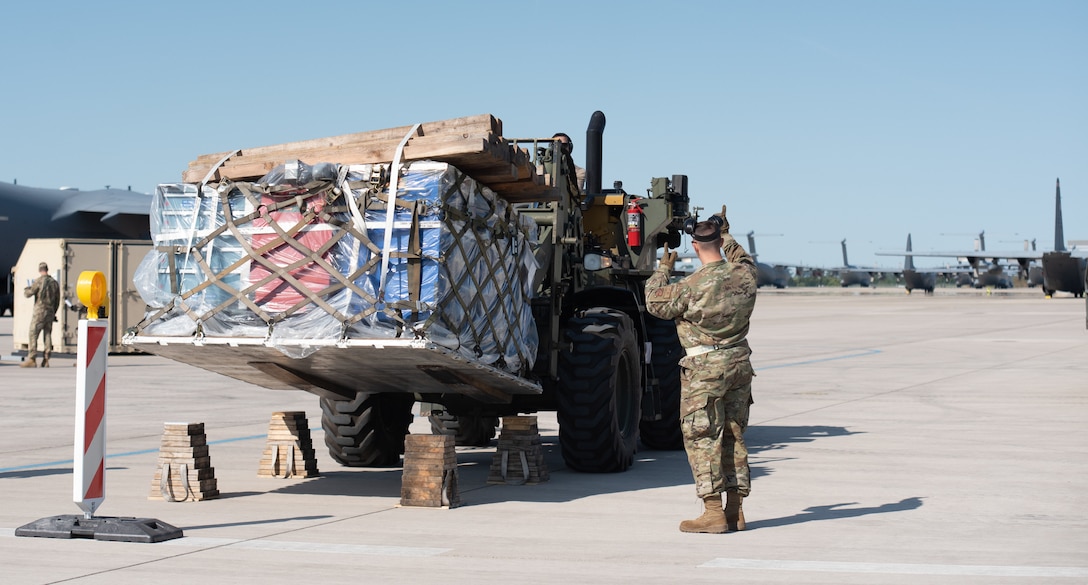 U.S. Airmen with the 156th Wing, Puerto Rico National Guard and the 123rd Contingency Response Element, 123rd Airlift Wing, Kentucky National Guard, move cargo on the ramp in preparation for exercise Air Defender 2023 (AD23) at Wunstorf Air Base, Germany, June 1, 2023. Exercise AD23 integrates both U.S and allied air-power to defend shared values, while leveraging and strengthening vital partnerships to deter aggression around the world. (U.S. Air National Guard photo by Senior Master Sgt. Vicky Spesard)