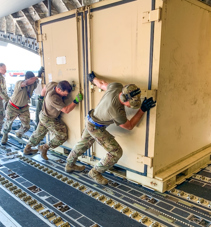 U.S. Airmen with the 105th Airlift Wing, Puerto Rico National Guard and the 123rd Contingency Response Element with the 123rd Airlift Wing, Kentucky National Guard, shift cargo to be off-loaded in preparation for exercise Air Defender 2023 (AD23) at Wunstorf Air Base, Germany, June 1, 2023. Exercise AD23 integrates both U.S and allied air-power to defend shared values, while leveraging and strengthening vital partnerships to deter aggression around the world. (U.S. Air National Guard photo by Senior Master Sgt. Vicky Spesard)