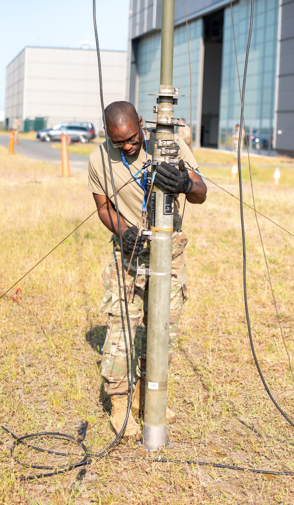 U.S. Air Force Staff Sgt. Anfernee Joseph, expeditionary communications technician with the 146th Contingency Response Flight, 146th Wing, California National Guard, deploys an antenna mast at Wunstorf Air Base, Germany, June 5, 2023, to assist airlift operations in support of exercise Air Defender 2023 (AD23). Exercise AD23 integrates both U.S and allied air-power to defend shared values, while leveraging and strengthening vital partnerships to deter aggression around the world. (U.S. Air National Guard photo by Senior Master Sgt. Vicky Spesard)