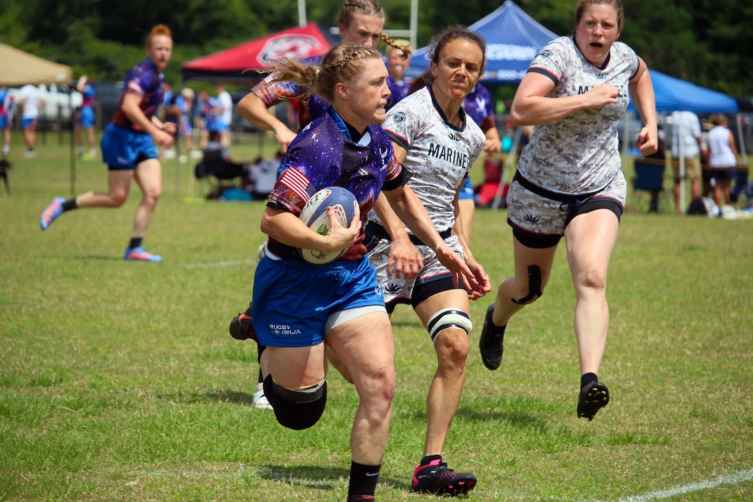 1st Lt. Adrienne Yoder of Little Rock AFB, Arkansas drives down the field on her way for the score during their match against Marine Corps of the 2023 Armed Forces Sports Women's Rugby Championship held in conjunction with the Cape Fear 7's Rugby Tournament in Wilmington, N.C.  Championship features teams from the Army, Marine Corps, Navy, Air Force (with Space Force players), and Coast Guard.  (Dept. of Defense Photo by Mr. Steven Dinote, Released)