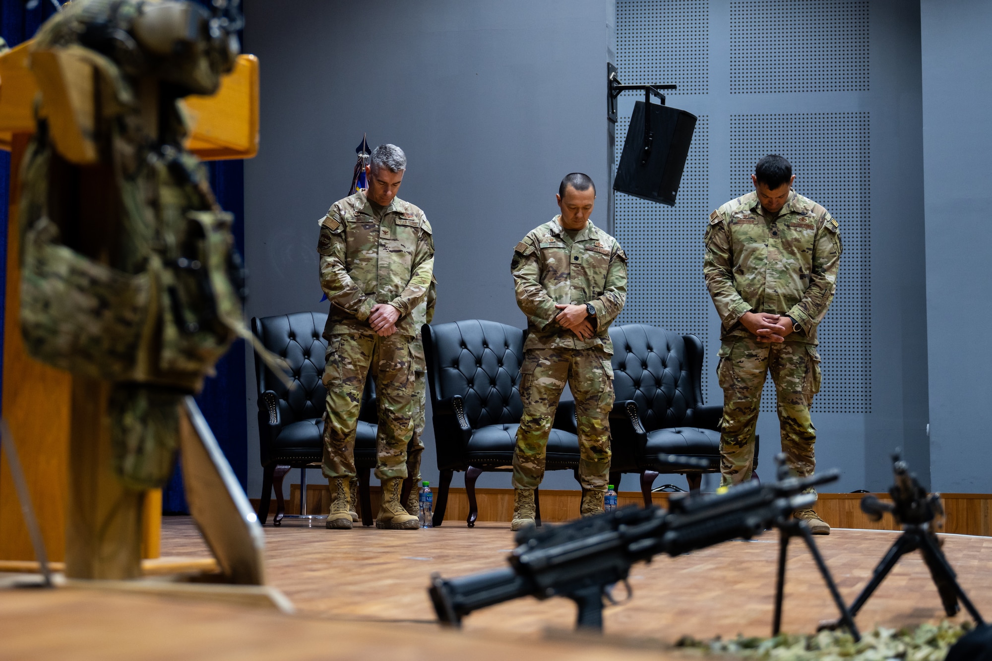 From left, U.S. Air Force Col. George Buch, Jr., 386th Air Expeditionary Wing commander, Lt. Col. Tito Ruiz, outgoing 386th Security Forces Squadron commander, and Lt. Col. Michael E. Wetlesen, incoming 386th ESFS commander, bow their heads during an invocation at a change of command ceremony at Ali Al Salem Air Base, Kuwait, June 23, 2023. Ruiz is relinquishing command to Wetlesen. (U.S. Air Force photo by Staff Sgt. Kevin Long)
