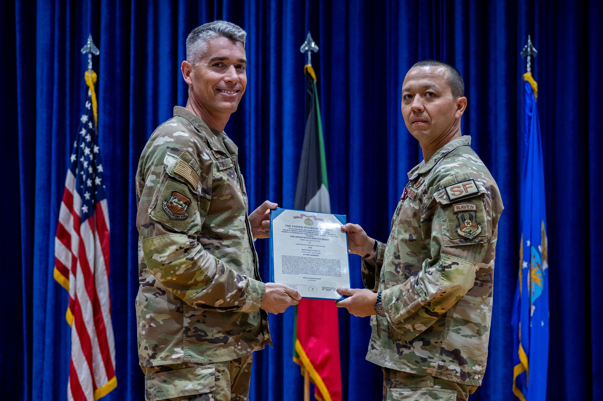 U.S. Air Force Col. George Buch, Jr., 386th Air Expeditionary Wing commander, presents a Meritorious Service Medal to Lt. Col. Tito Ruiz, outgoing 386th Security Forces Squadron commander, during a change of command ceremony at Ali Al Salem Air Base, Kuwait, June 23, 2023. The medal was presented in recognition of Ruiz’s accomplishments after a year-long command of the 386th ESFS. (U.S. Air Force photo by Staff Sgt. Kevin Long)