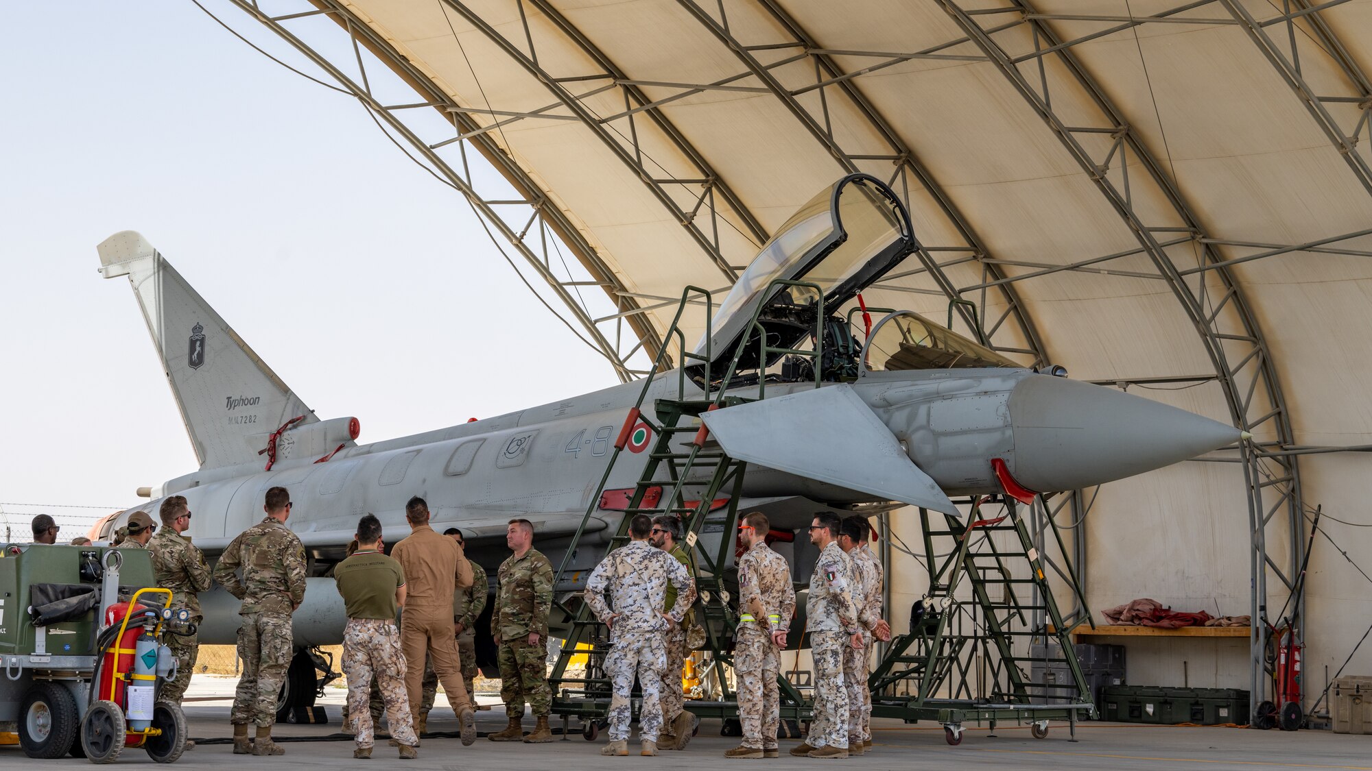 Service members of the U.S. Air Force, the U.S. Army and the Italian Air Force take a tour of an Italian Eurofighter Typhoon at Ali Al Salem Air Base, Kuwait, June 22, 2023. Sharing our knowledge and capabilities with one another is critical to increasing the interoperability of our forces, and projecting decisive coalition combat power. (U.S. Air Force photo by Staff Sgt. Kevin Long)