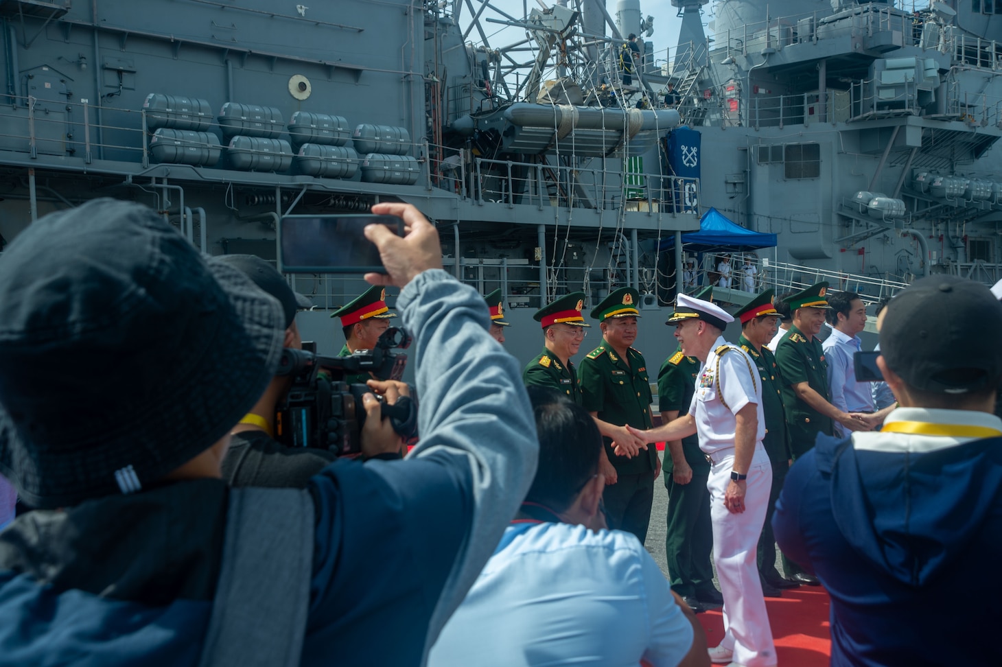 DA NANG, Vietnam (June 25, 2023) – Capt. Bill Johnson, Chief of Staff of Commander, Task Force 70/Carrier Strike Group 5, shakes hands with a Vietnamese military officer during an arrival ceremony for the U.S. Navy’s only forward-deployed carrier, USS Ronald Regan (CVN 76), carrier strike group (CSG) in Da Nang, Vietnam June 25, 2023. This marks Ronald Reagan’s first visit to the country since diplomatic relations were re-established. Ronald Reagan CSG is forward-deployed to the 7th Fleet area of operation in support of a free and open Indo-Pacific. (U.S. navy photo by Mass Communication Specialist 2nd Class Askia Collins)